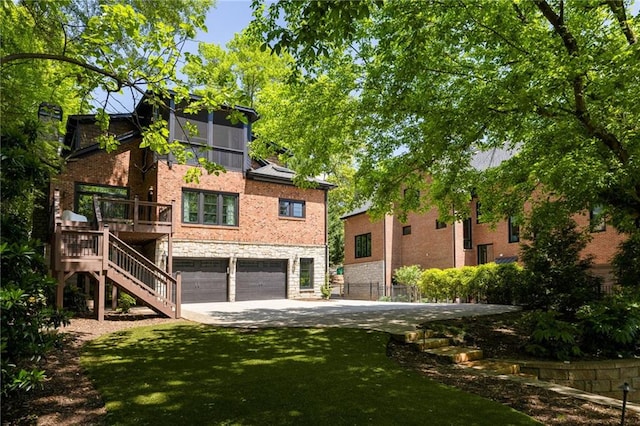 2015 N Decatur Rd NE, Atlanta, GA 30307 - rear view of property featuring a lawn, a garage, stairway, concrete driveway, and brick siding