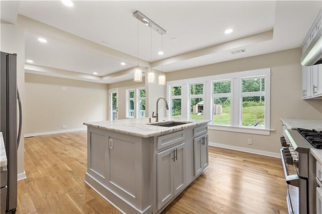 2552 Scenic Hwy S, Snellville, GA 30078 - kitchen with a raised ceiling, appliances with stainless steel finishes, baseboards, a sink, and light wood finished floors