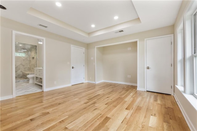 2552 Scenic Hwy S, Snellville, GA 30078 - unfurnished bedroom with a raised ceiling, light wood-style flooring, recessed lighting, connected bathroom, and baseboards