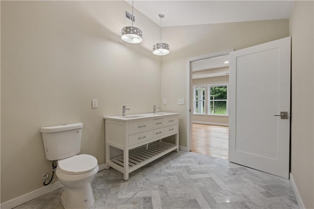 2552 Scenic Hwy S, Snellville, GA 30078 - bathroom with baseboards, toilet, double vanity, and high vaulted ceiling