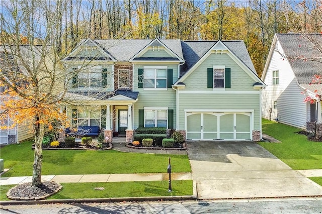 view of front of home featuring an attached garage, driveway, and a front lawn