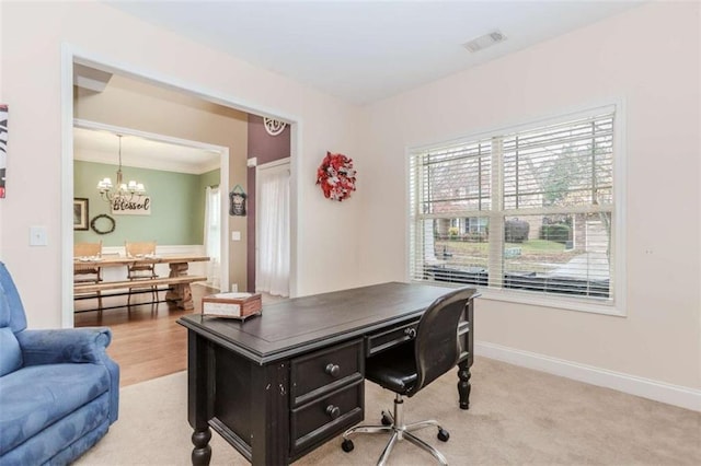 home office featuring light carpet, baseboards, visible vents, and a notable chandelier