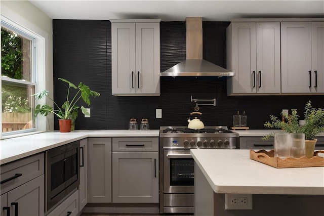 1218 Crestwood Dr SE, Atlanta, GA 30316 - kitchen featuring wall chimney exhaust hood, stainless steel appliances, gray cabinets, and light countertops