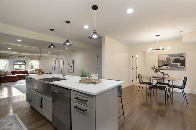 1218 Crestwood Dr SE, Atlanta, GA 30316 - kitchen with dishwasher, a chandelier, dark wood-style floors, light countertops, and an island with sink
