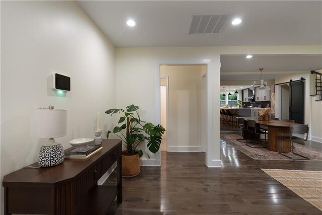 1218 Crestwood Dr SE, Atlanta, GA 30316 - corridor featuring a barn door, dark wood finished floors, and recessed lighting
