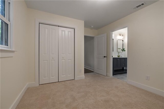 1218 Crestwood Dr SE, Atlanta, GA 30316 - unfurnished bedroom with carpet flooring, a closet, and connected bathroom