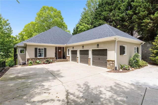 99 Bree Ln, Canton, GA 30114 - single story home featuring a garage, driveway, stone siding, and stucco siding