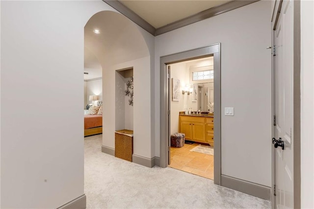 99 Bree Ln, Canton, GA 30114 - hallway featuring baseboards, arched walkways, crown molding, and light carpet