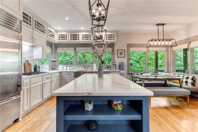 99 Bree Ln, Canton, GA 30114 - kitchen with open shelves, light wood-style floors, white cabinetry, light stone counters, and appliances with stainless steel finishes