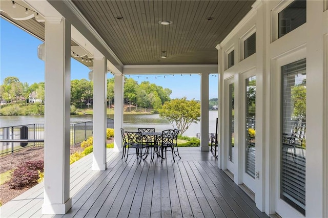 99 Bree Ln, Canton, GA 30114 - wooden deck featuring a water view, fence, and outdoor dining space