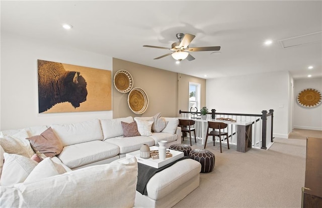 living room with light carpet and ceiling fan