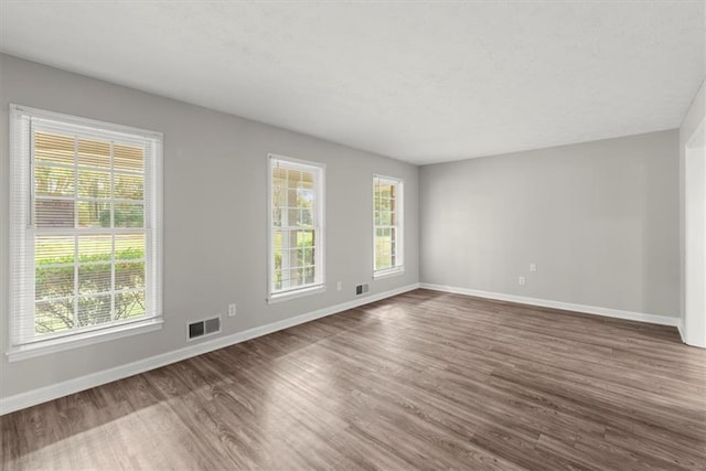 empty room with dark wood-type flooring