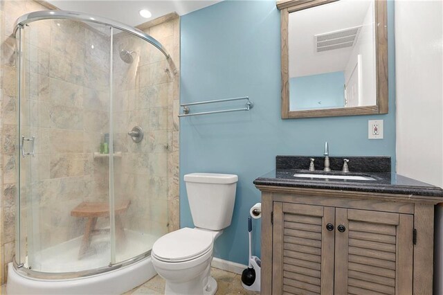 full bathroom with a shower stall, toilet, vanity, baseboards, and recessed lighting