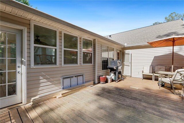 wooden deck with a grill