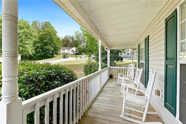wooden terrace featuring covered porch