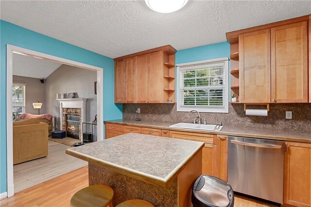 kitchen with dishwasher, open shelves, light wood-style floors, plenty of natural light, and a textured ceiling