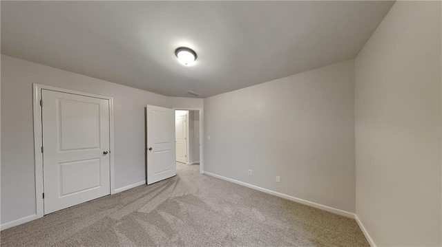 unfurnished bedroom featuring baseboards and carpet floors