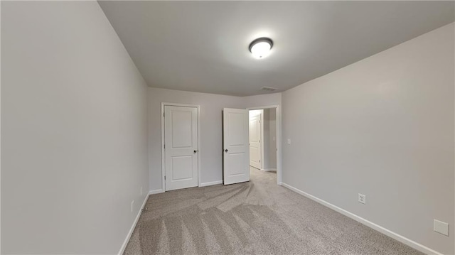 unfurnished bedroom featuring baseboards and carpet flooring