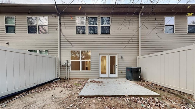 back of property with cooling unit, a patio, and a fenced backyard