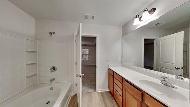 full bath featuring visible vents, vanity, shower / tub combination, and wood finished floors