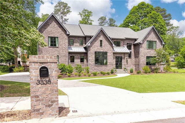 3338 Breton Cir NE, Brookhaven, GA 30319 - view of front facade with a front yard, a standing seam roof, and brick siding