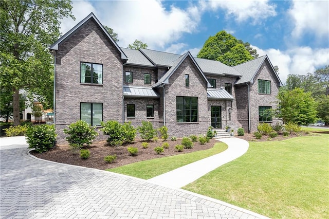 3338 Breton Cir NE, Brookhaven, GA 30319 - view of front facade featuring a standing seam roof, a front yard, and brick siding