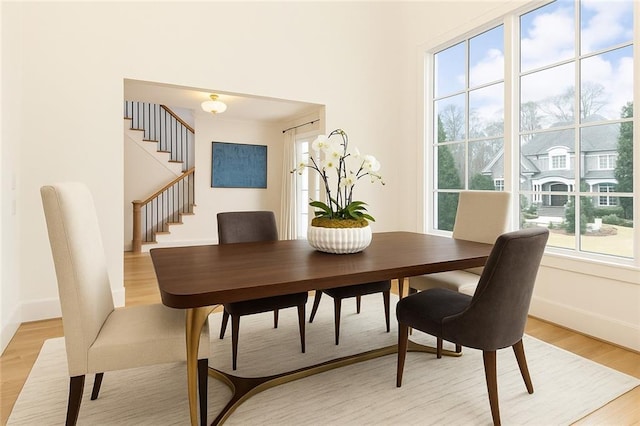 3338 Breton Cir NE, Brookhaven, GA 30319 - dining area featuring light wood-style flooring, baseboards, and stairway