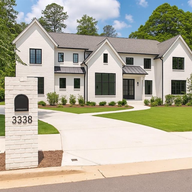 3338 Breton Cir NE, Brookhaven, GA 30319 - modern farmhouse style home featuring a standing seam roof, a front lawn, and a shingled roof