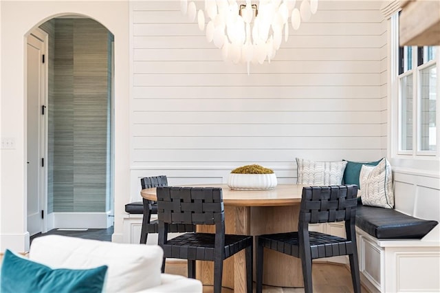 3338 Breton Cir NE, Brookhaven, GA 30319 - dining space featuring arched walkways, a chandelier, wood finished floors, breakfast area, and plenty of natural light