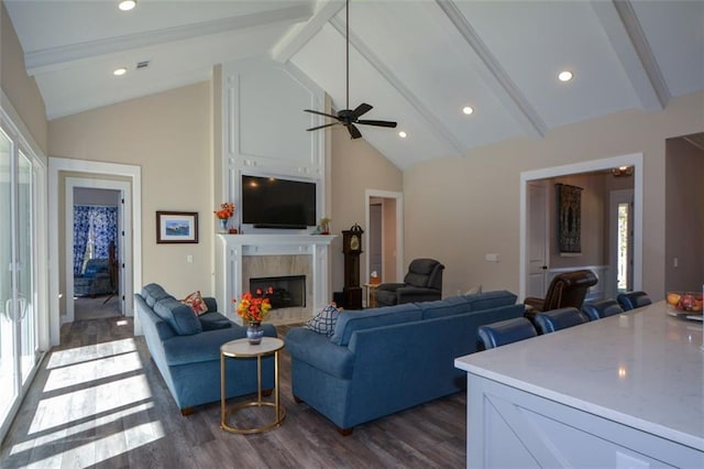 living room with a healthy amount of sunlight, dark hardwood / wood-style flooring, and beam ceiling