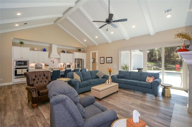 living room featuring beamed ceiling, high vaulted ceiling, ceiling fan, and dark wood-type flooring