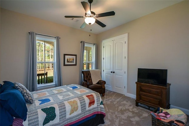 bedroom with carpet, ceiling fan, and a closet