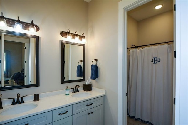 bathroom featuring a shower with curtain and vanity