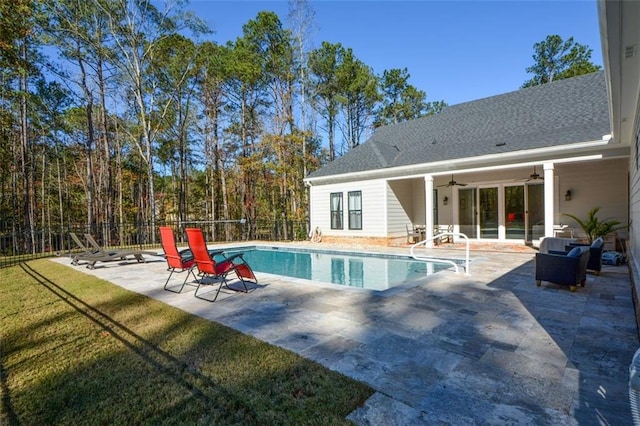 view of swimming pool with a lawn, ceiling fan, and a patio