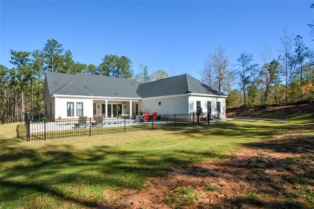 back of house with a lawn, a patio area, and a pool