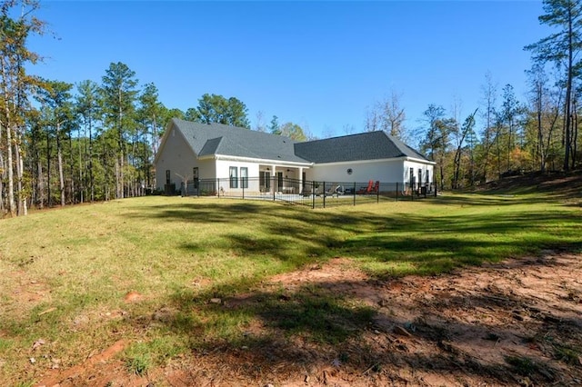 rear view of property with a yard