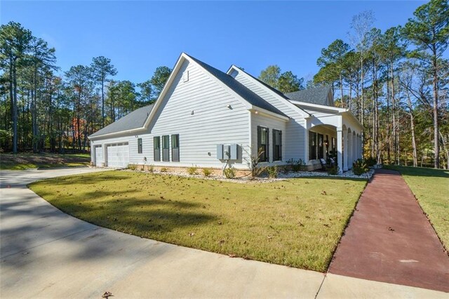 view of property exterior featuring a garage and a lawn