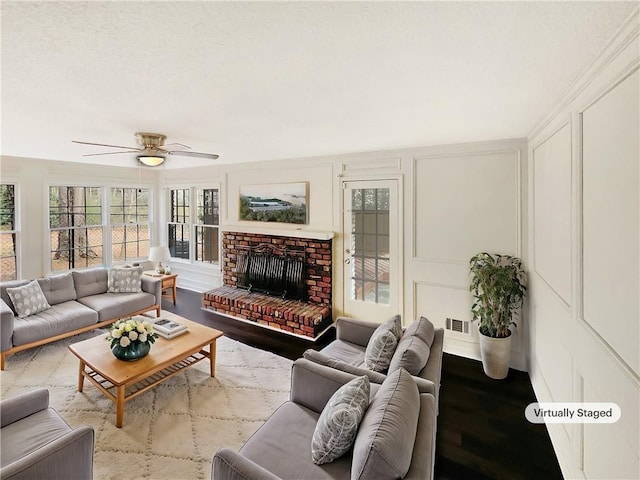 sunroom / solarium with a fireplace and ceiling fan