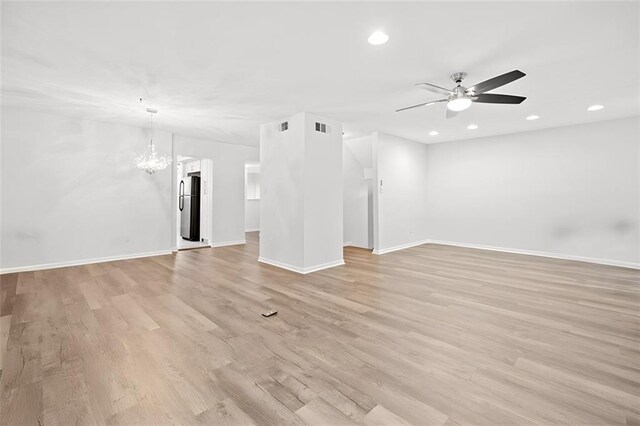 unfurnished room with light hardwood / wood-style floors and a notable chandelier