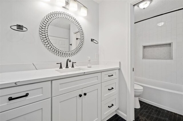 bathroom with tile patterned flooring, vanity, toilet, and a shower with shower door