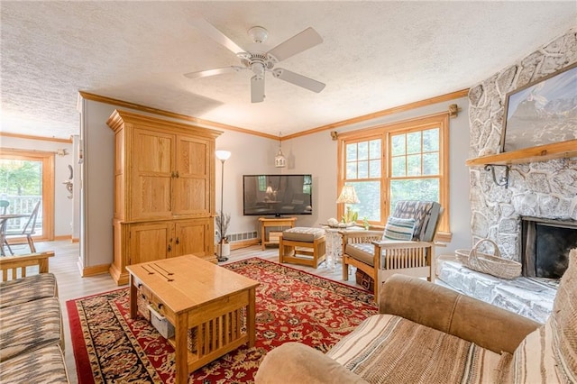 5848 Kingswood Ct, Norcross, GA 30093 - living room with crown molding, ceiling fan, a stone fireplace, a textured ceiling, and light wood-style flooring