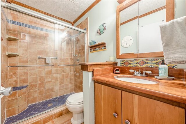 5848 Kingswood Ct, Norcross, GA 30093 - bathroom with ornamental molding, a stall shower, a textured ceiling, and vanity