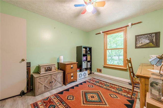 5848 Kingswood Ct, Norcross, GA 30093 - home office featuring light wood-style flooring, a textured ceiling, and ceiling fan