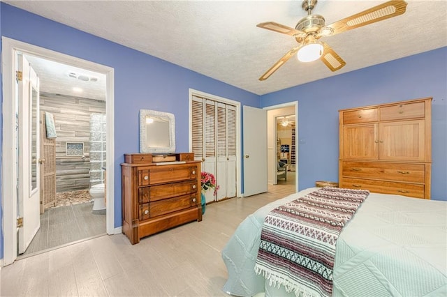 5848 Kingswood Ct, Norcross, GA 30093 - bedroom featuring light wood finished floors, a closet, connected bathroom, and a ceiling fan