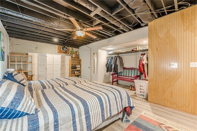 5848 Kingswood Ct, Norcross, GA 30093 - bedroom featuring wood finished floors, wooden walls, and a ceiling fan