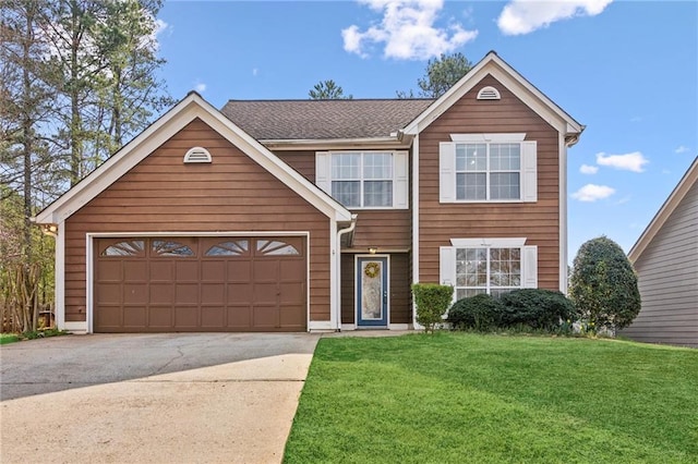 traditional-style house featuring an attached garage, driveway, and a front yard