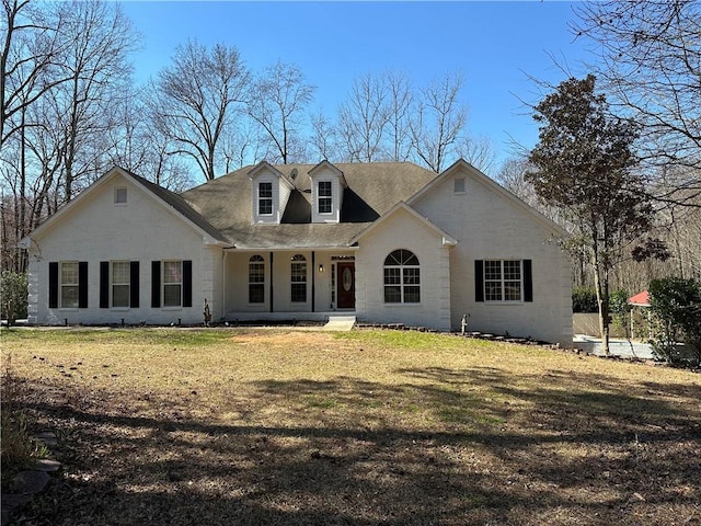 view of front of house with covered porch and a front lawn