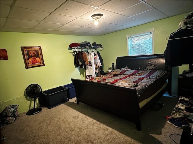 carpeted bedroom with a paneled ceiling