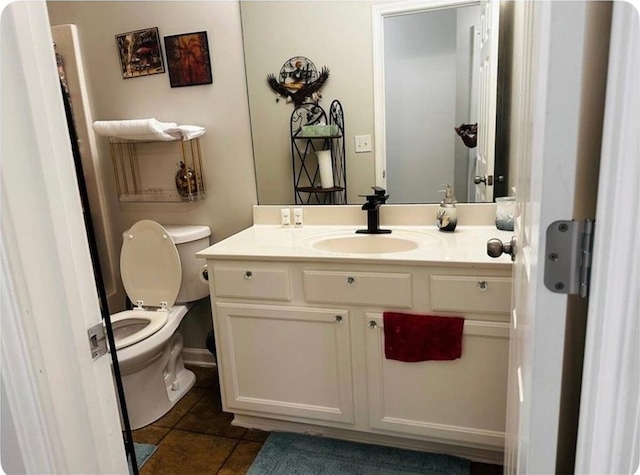 bathroom featuring toilet, tile patterned floors, and vanity