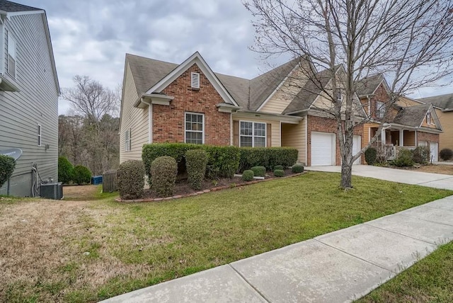 view of front of property with a garage, a front lawn, and central air condition unit